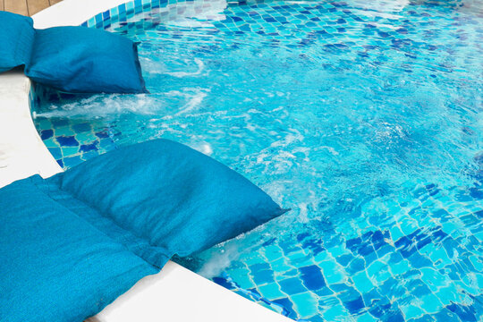 Empty swimming pool with sunbed and white umbrella in resort hotel for vacation leisure and white sand,resort neary sea and beach in summer.