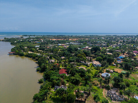Aerial view of the coastal landscape and residential area along the riverbank in Monrovia, Montserrado, Liberia.
