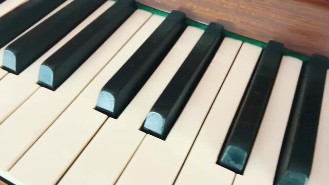Close up of black and white keys of a wooden acoustic piano with selective focus, music, culture 