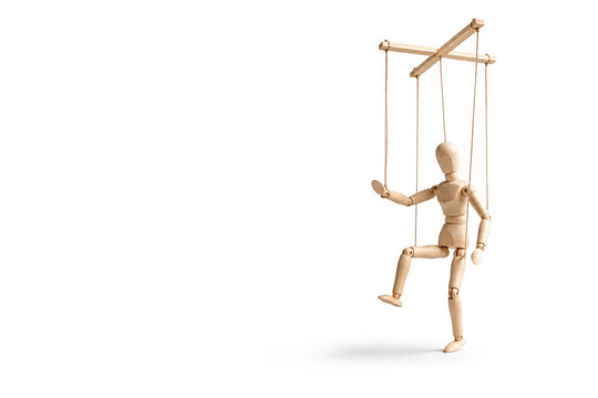 Wooden puppet hangs from strings on white background. Space for text.