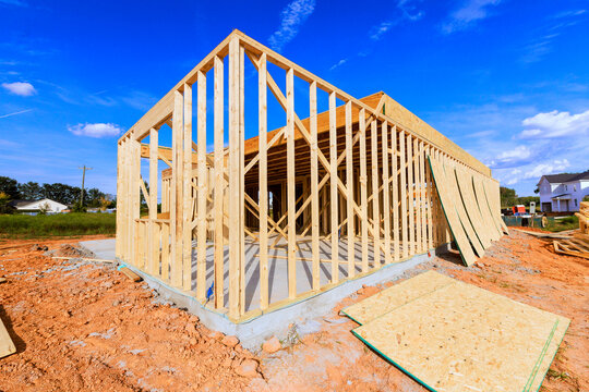 Wooden beams frames are being built for house in residential neighborhood
