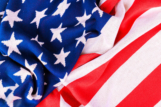 American flag red white stripes with blue field containing white stars during an outdoor event in America.