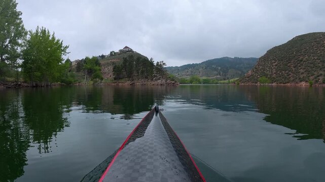 Immersive POV from a kayak - paddling on Horsetooth Reservoir in Fort Collins, Colorado, cloudy summer morning scenery 