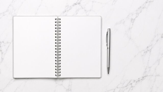 Minimalist flat lay mockup of an open blank spiral planner resting on a white marble surface