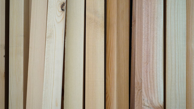 Vertical samples of natural pine lumber planks and timber boards