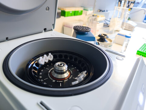 Brussels, Belgium. Open laboratory centrifuge with DNA extraction sample tubes prepared for molecular biology workflow