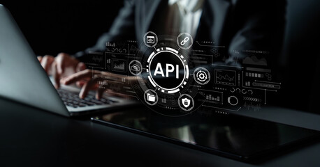 Professional Hands Typing on Laptop Keyboard with API Symbol Overlaid on Screen, Representing...