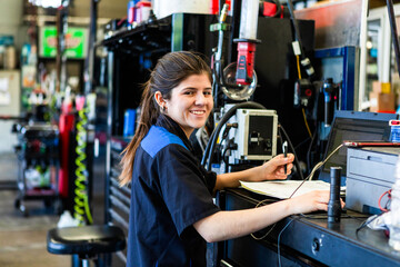 Smiling mechanic in busy workshop