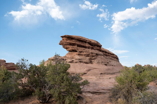 Unusual rock formations in an alien landscape in Moab Utah. Summer day in the desert in Arches National Park.  Blue skies with a few wispy clouds, summer at Arches National Park, Moab, UT, USA.