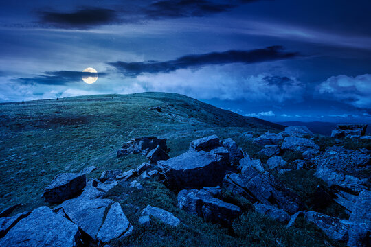 carpathian mountain landscape on summer night. mysterious background for outdoor adventure in the dark. transcarpathia green hill with rocks in foll moon light
