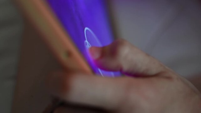 Skilled child controls fast tablet game with precise finger movements during focused digital play in tight extreme close up.
