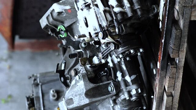 old gear shift box for front-wheel drive car cleaning from dirt with chemical agent and rinsing with water vertical video