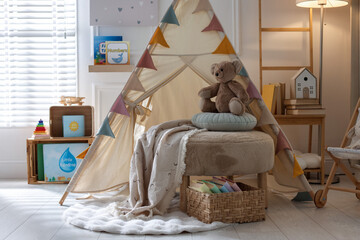 Beautiful wigwam, ottoman, different toys and books in child's room © New Africa