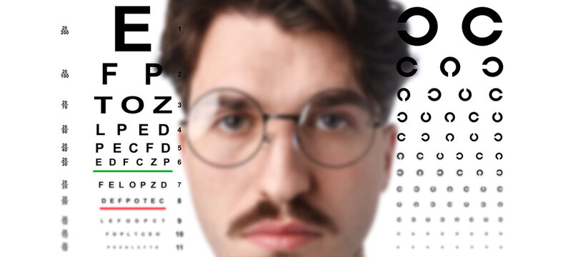 Man in glasses and eye chart on white background, selective focus. Vision check