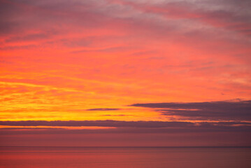 Fototapeta premium Beautiful orange sunset over the sea. Evening sea landscape