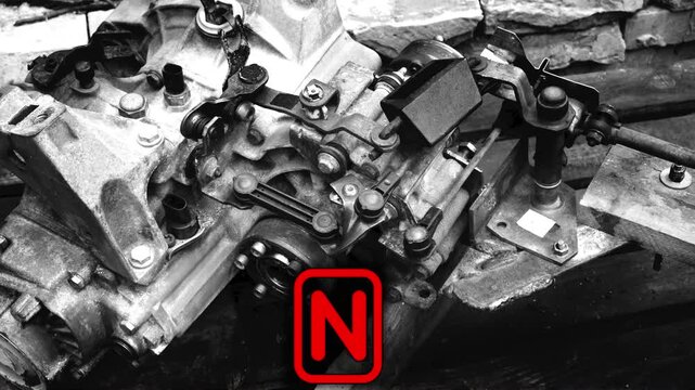 old gear shift box for a front-wheel drive car example of how to shift numbers and letters to understand how the mechanism works black and white video with red fonts