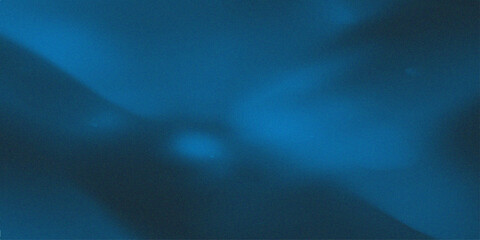 Abstract dark blue background with blurry light spots. © mehek
