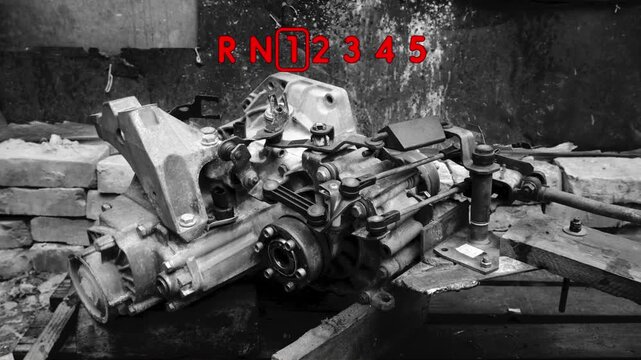 old gear shift box for a front-wheel drive car example of how to shift numbers and letters to understand how the mechanism works black and white video with red fonts