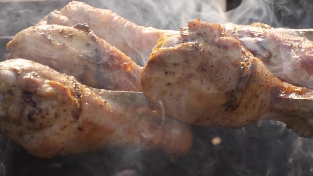 Chicken thighs are being grilled on the barbecue.
