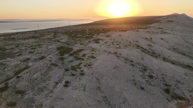 Aerial sunset footage over Pag Island highlighting dramatic light, barren landscape and Mediterranean atmosphere