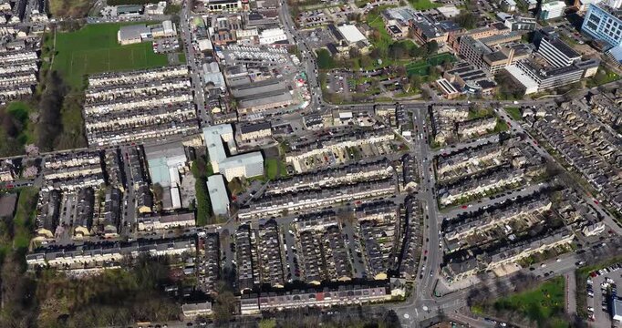 Aerial drone footage of the City of Bradford in Yorkshire in the UK showing the urban skyline historic architecture busy roads commercial districts residential areas and the wider Yorkshire landscape