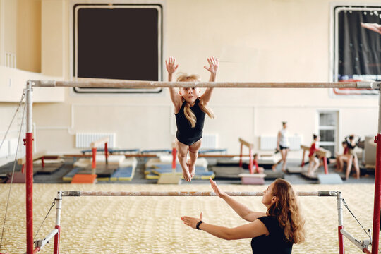 Prepare young child athlete gymnast on balance beam