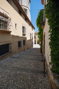 Cobblestone alleyway with stairs and ancient buildings in altafulla