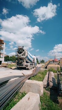 Concrete mixer truck reversing on construction site