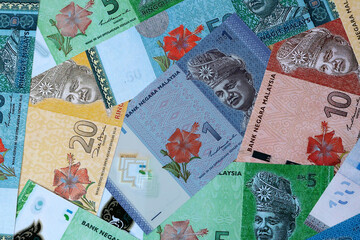 Malaysian ringgit money bills in pile on table. Malaysia MYR currency cash close up © Viktor