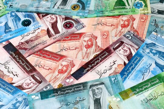 Jordanian dinar money bills in pile on table. Jordan JOD currency cash close up