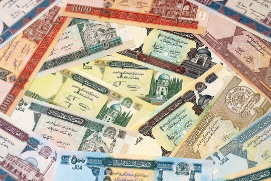Afghan afghani money bills in pile on table. Afghanistan AFN currency cash close up