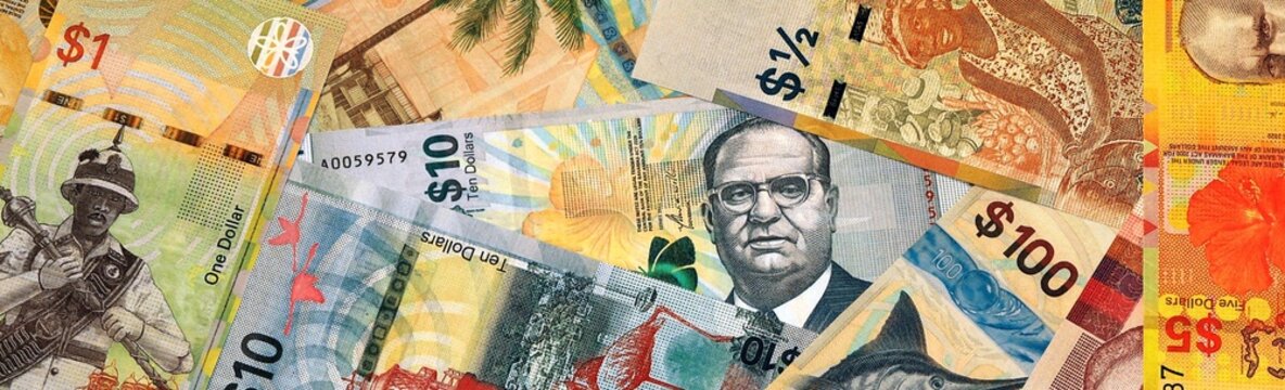 Bahamian dollar money bills in pile on table. Bahamas BSD currency cash close up