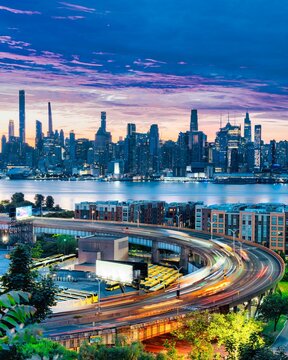New York City skyline at blue hour with traffic light trails and Hudson River