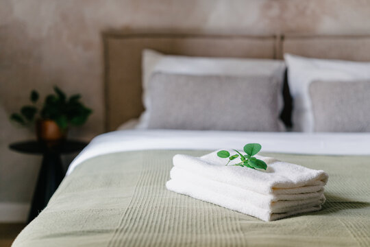 White towels arranged on a bed in a hotel room with modern design features