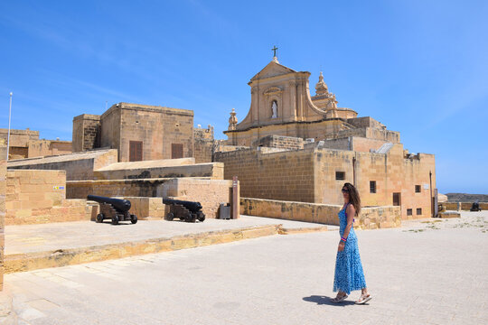 Woman in Blue Dress Exploring the Victoria Citadel in Gozo, Malta