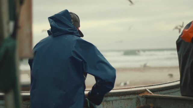 Fisherman preparing nets on boat at sea