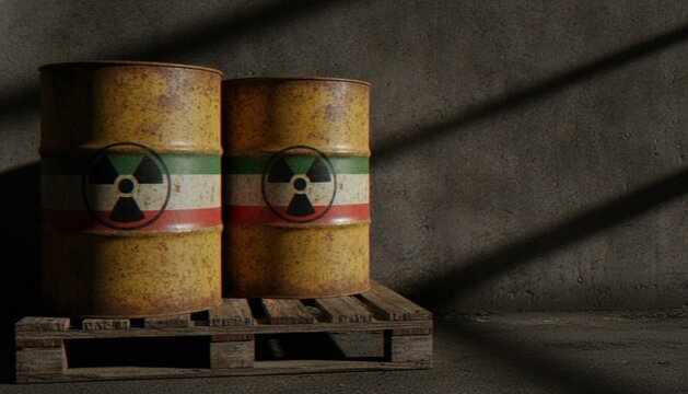 Two rusty metal barrels with a nuclear warning symbol and the colors of the Iranian flag on a wooden pallet in a dark warehouse.