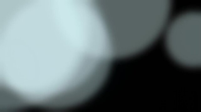 Abstract Blurry Light Bokeh Background with Soft Grey and Blue Tones.