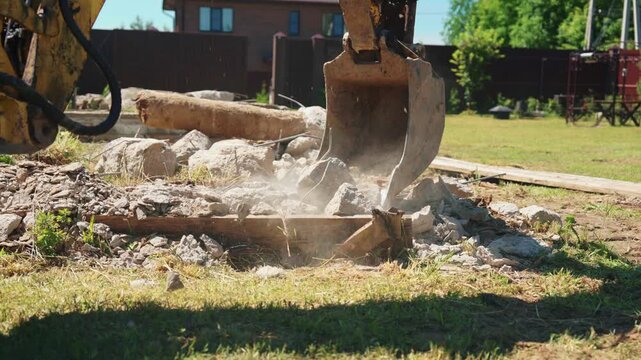 Heavy machinery dismantling reinforced concrete structures at a construction site