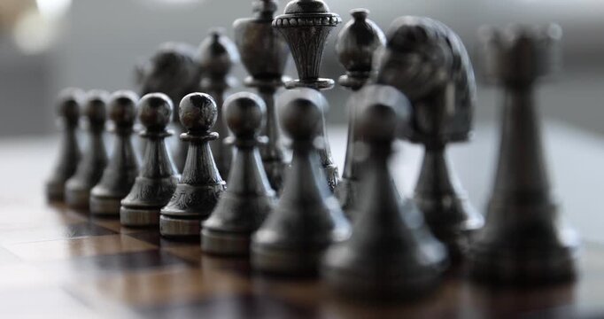 Chess pieces on game board, closeup. Camera refocusing