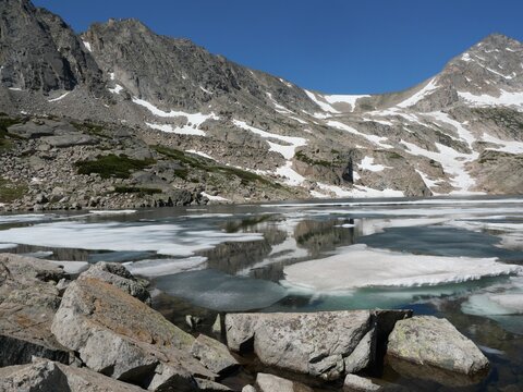 Partially frozen Blue Lake in early summer, Indian Peaks Wilderness, Colorado