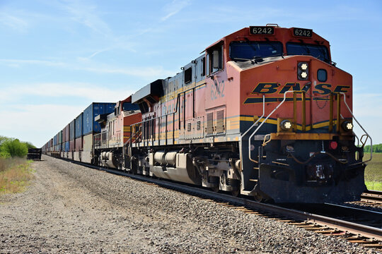 A pair of Burlington Northern Santa Fe locomotives provide front-end power in leading an eastbound intermodal freight train through rural north central Illinois.