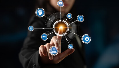 Fototapeta premium A businesswoman interacts with a futuristic touchscreen interface featuring various technology icons, symbolizing innovation, connectivity, and modern communication methods. Crux
