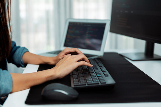 Cropped hands image of IT developer creating with typing information on pc with coding program information data website application, wearing jeans shirt surround safety analysis two screen. Stratagem.
