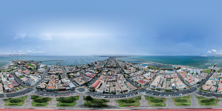 Aerial view of the coastal district of La Punta with its dense urban architecture, streets, and surrounding Pacific Ocean coastline in La Punta, Callao Region, Peru.