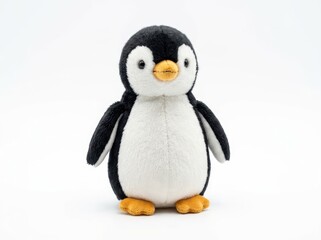 Fototapeta premium A cute plush penguin toy with black and white feathers and orange feet, standing on a plain surface