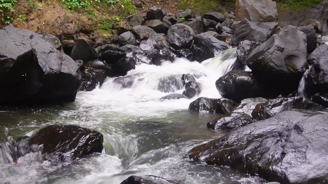 The calming river flow in the Curug Cinulang area, West Java, Indonesia