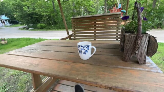 Having Coffee on a Gliding Picnic Table