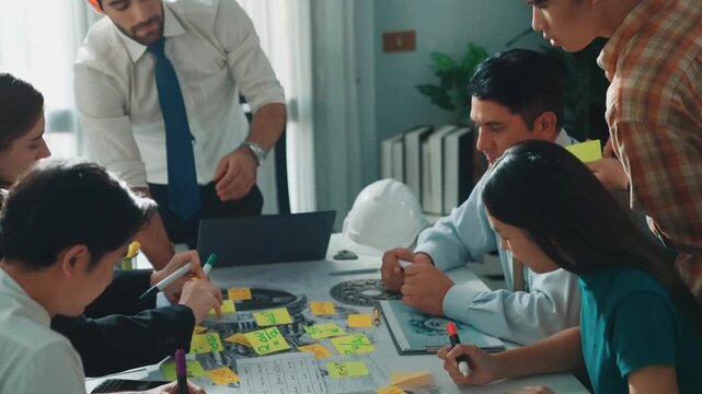 Group of diverse team planning strategy while sitting at table with project plan. Top aerial view of smart business people working together to brainstorm and design house construction. Alimentation.