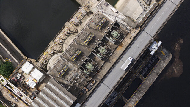 Aerial view of Fratel Dam showing the concrete structure, electrical transformers, and a road crossing the dam over the Tagus River in Amieira do Tejo, Portalegre, Portugal.